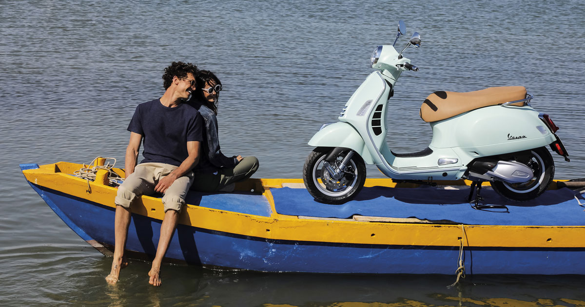 vespa gts 300 with couple relaxing on boat